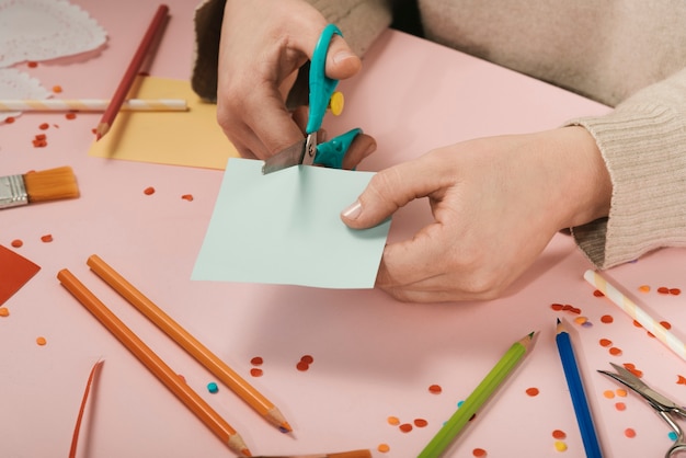 High angle of woman cutting blue paper