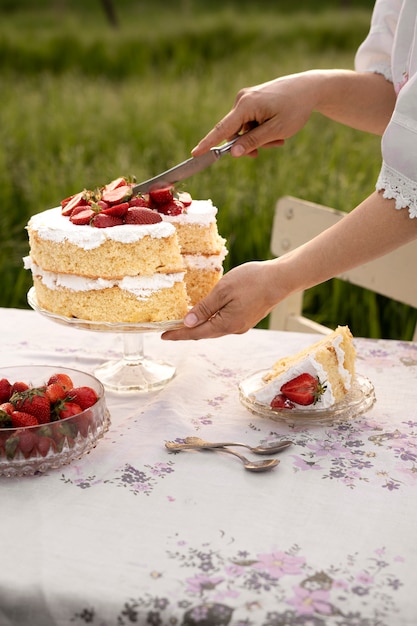 High angle woman cutting cake