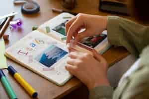 Free photo high angle woman doing creative journaling