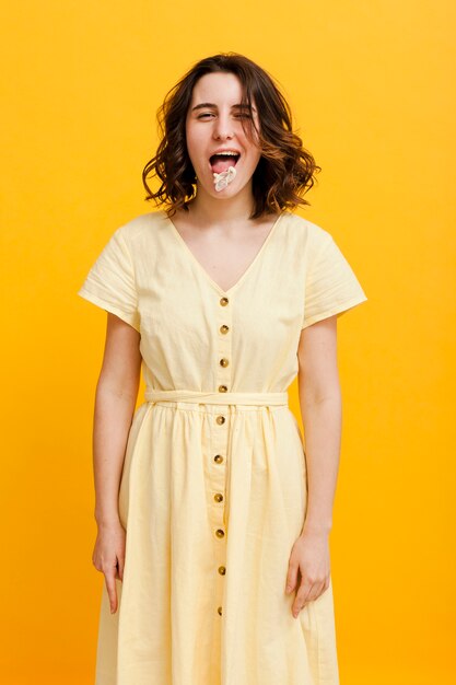 Free photo high angle woman eating bubble gum