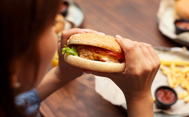 High angle of woman eating burger