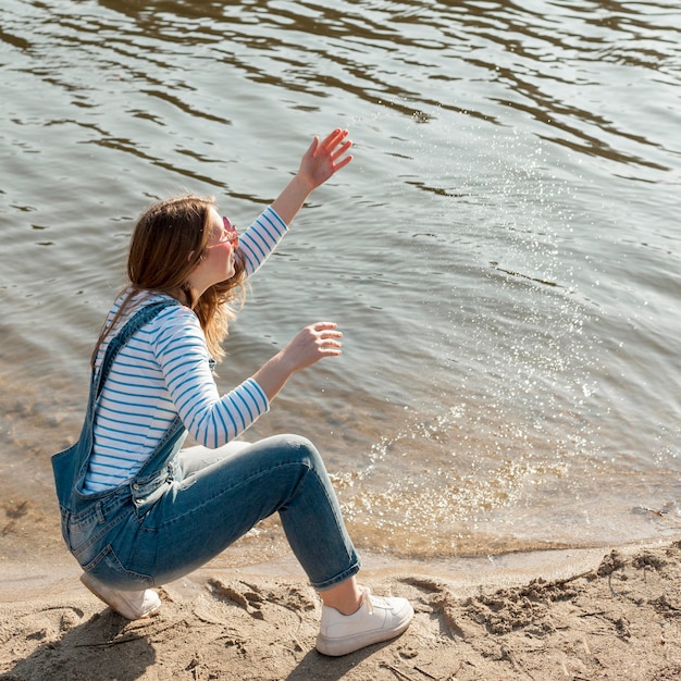 Free Photo high angle of woman enjoying her time by the lake