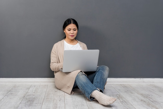 High angle woman on floor with laptop