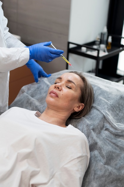 Free Photo high angle woman getting prp injection at clinic