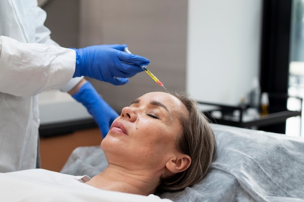 Free photo high angle woman getting prp treatment