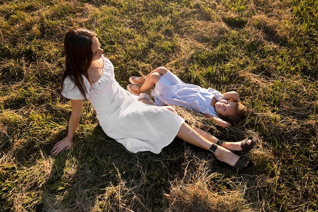 Free photo high angle woman and girl on ground