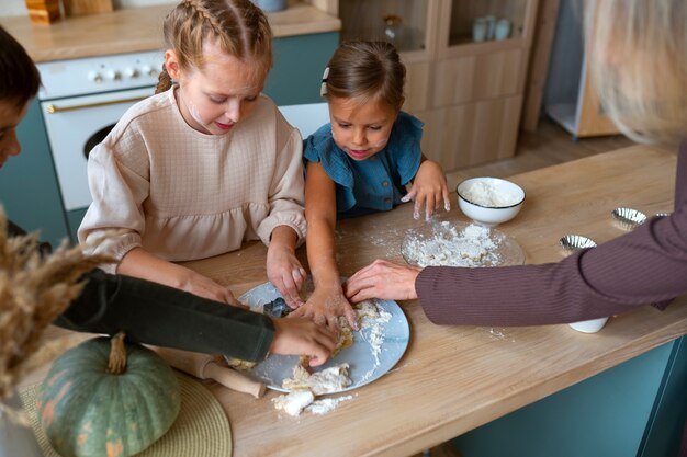 High angle woman helping kids cook