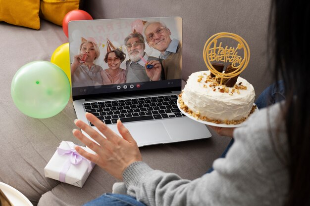 Free photo high angle woman holding birthday cake