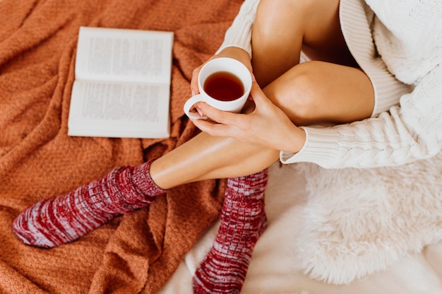 Free photo high angle woman holding a cup of tea