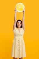 Free photo high angle woman holding giant lemon