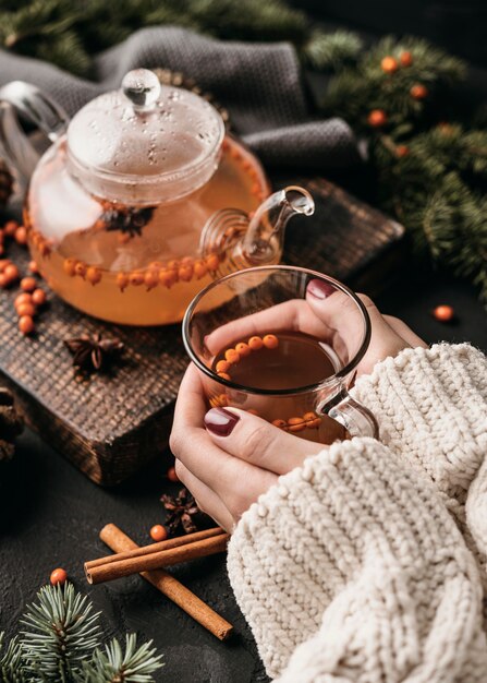 High angle woman holding glsss with sea buckthorn tea