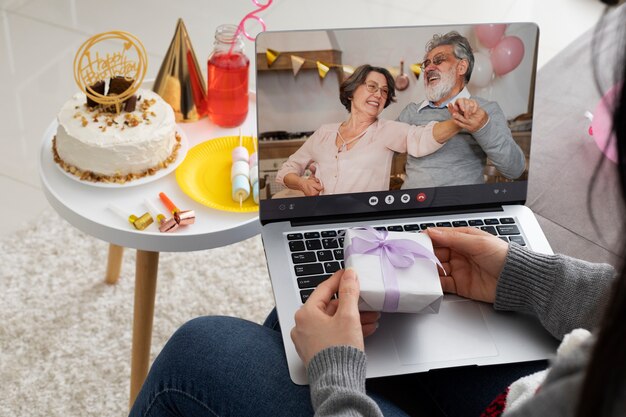 Free Photo high angle woman holding laptop and present