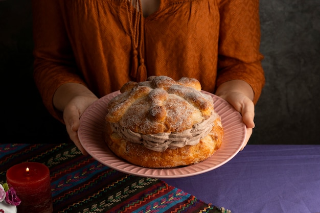 High angle of woman holding pan de muerte