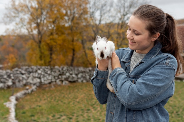 Free Photo high angle woman holding rabbit