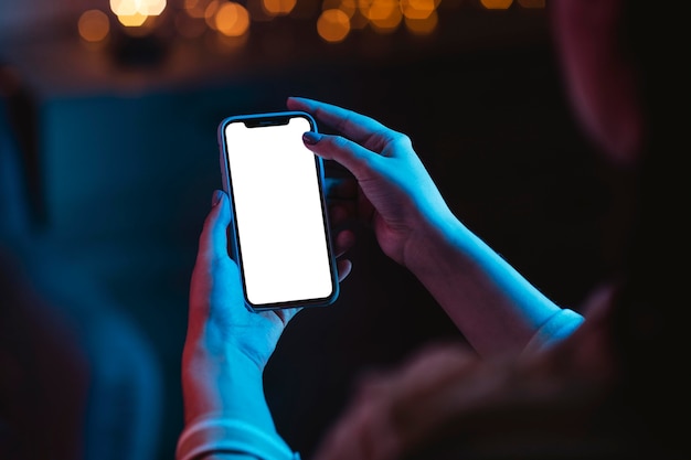 High angle of woman holding smartphone