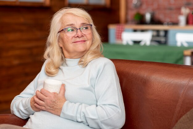 High angle woman at home drinking tea