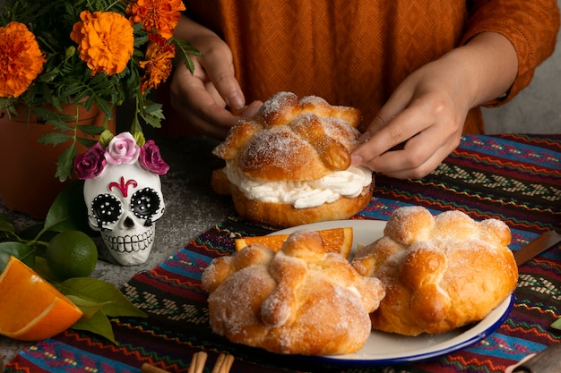 Free photo high angle of woman making pan de muerto