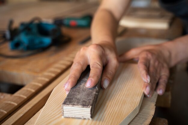 High angle woman measuring wood