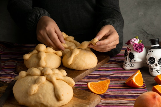 High angle woman preparing pan de muerto dough