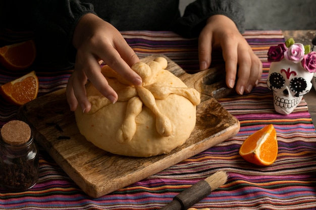 High angle woman preparing pan de muerto dough