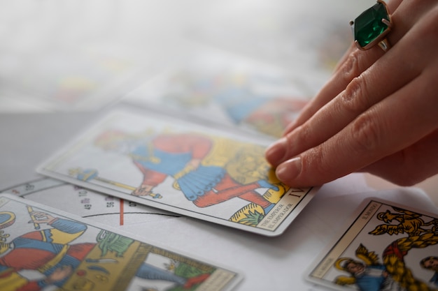 Free photo high angle woman reading tarot