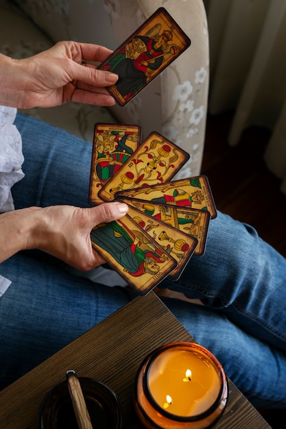 Free photo high angle woman reading tarot