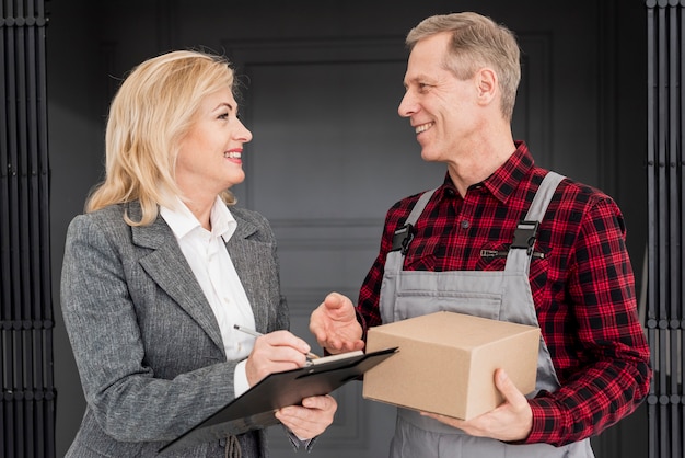 High angle woman signing for delivery