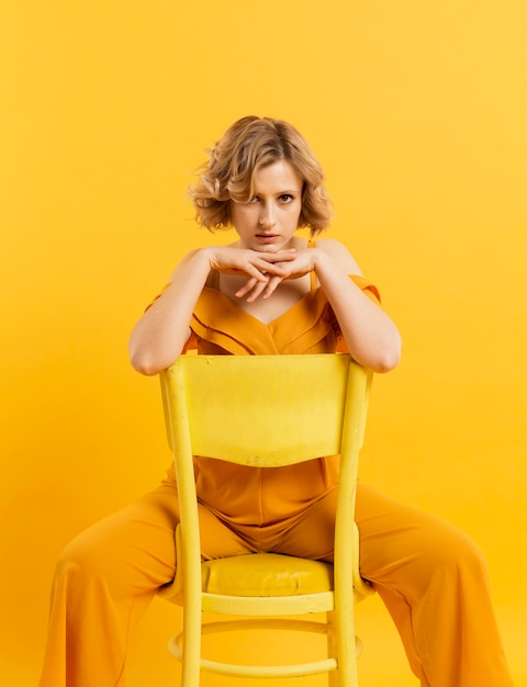 Free Photo high angle woman sitting on chair