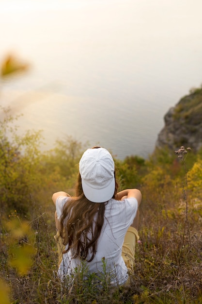 Free Photo high angle woman sitting in nature