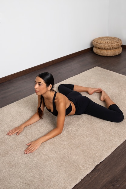 High angle woman stretching at home