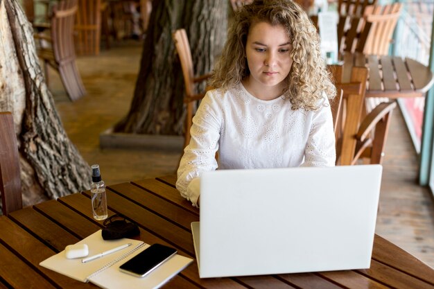 High angle woman at terrace working on laptop