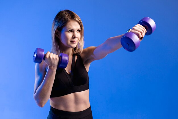 High angle woman training with weights