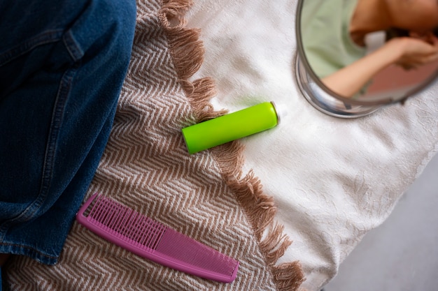 Free Photo high angle woman using dry shampoo at home