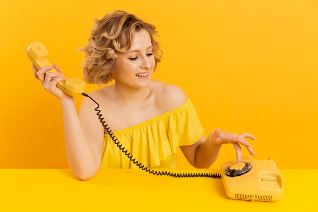 High angle woman using old phone