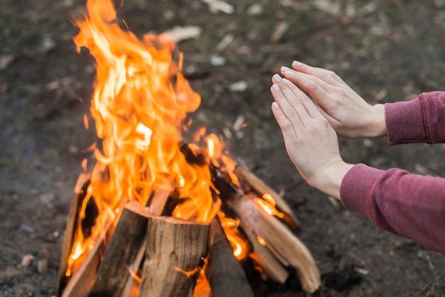 Free Photo high angle woman warming at bonfire