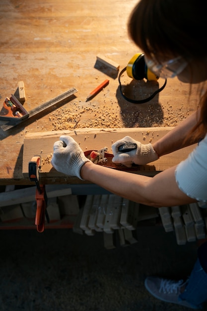 Free photo high angle woman wearing gloves