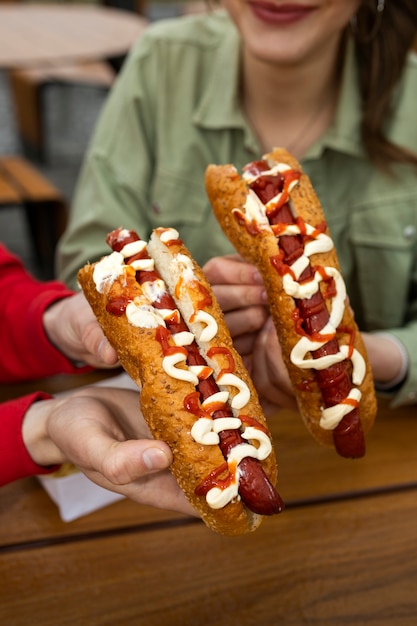 Free photo high angle woman with delicious hot dog