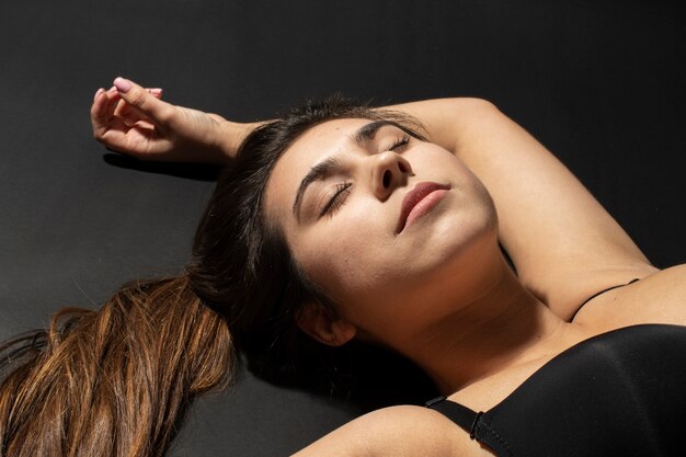 High angle woman with hydrated skin laying