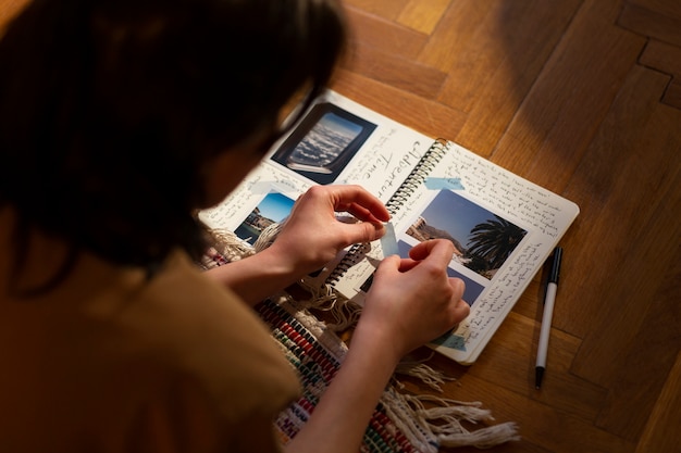 Free photo high angle woman with journal at home