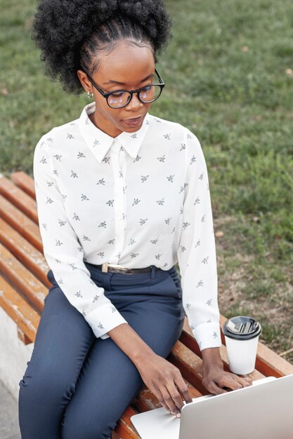 High angle woman with laptop outdoor