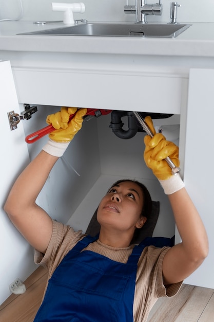 High angle woman working as plumber