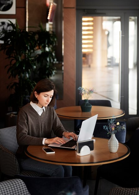 High angle woman working on laptop