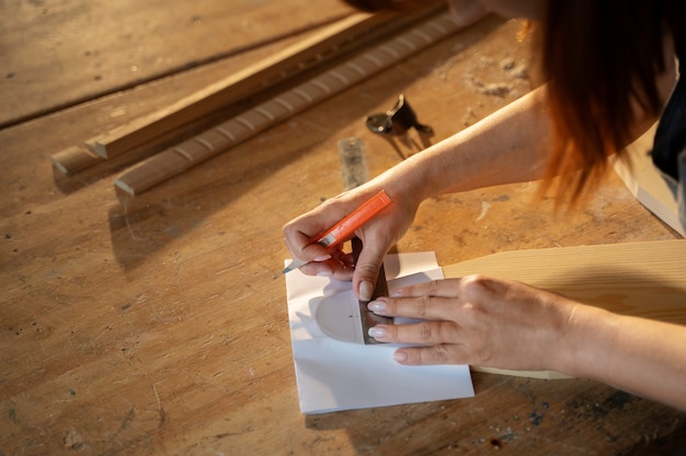 High angle woman working with ruler