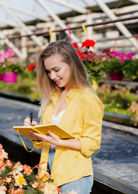 Free photo high angle woman writing in agenda