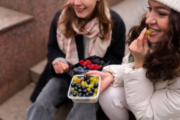 High angle women eating berries