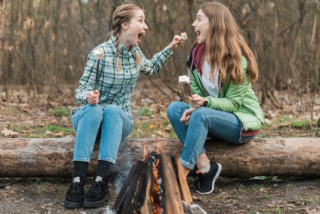 High angle women eating marshmallow