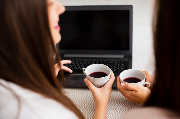 High angle women at home using laptop