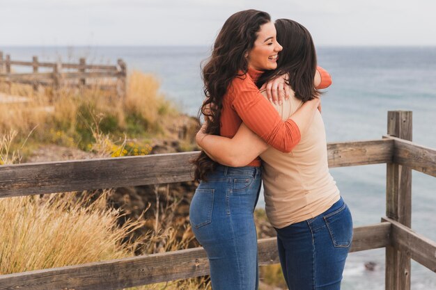 High angle women hugging