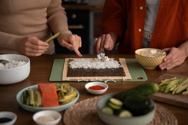 High angle women learning to make sushi