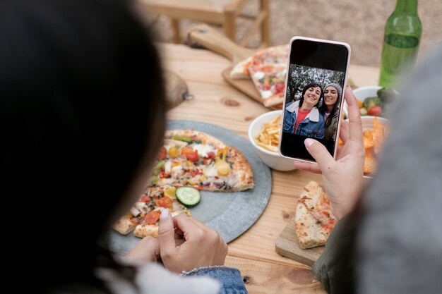 Free photo high angle women taking selfie